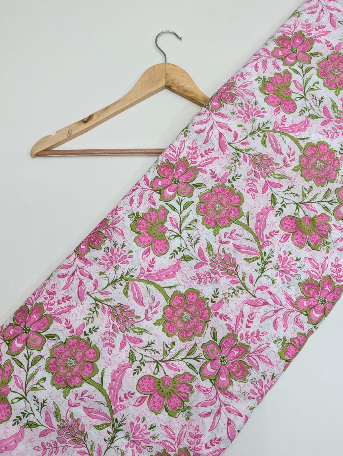 Pink floral cotton fabric with green leaves