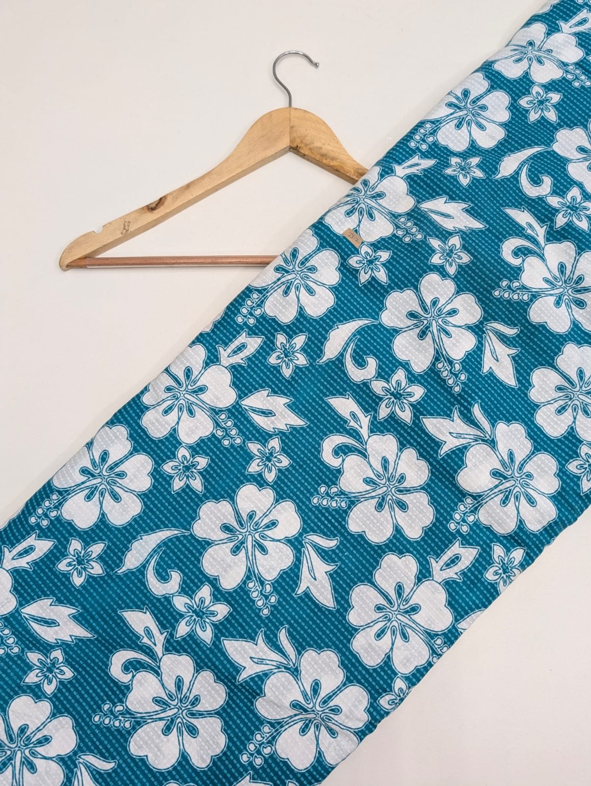 Teal fabric with white floral cotton print