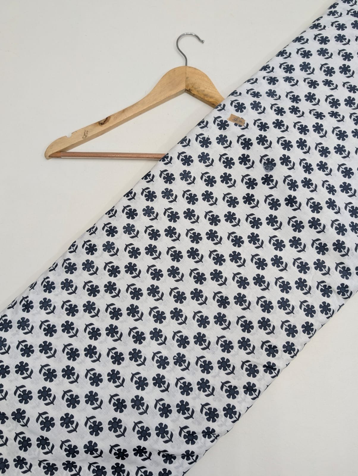 White cotton fabric with black floral motifs