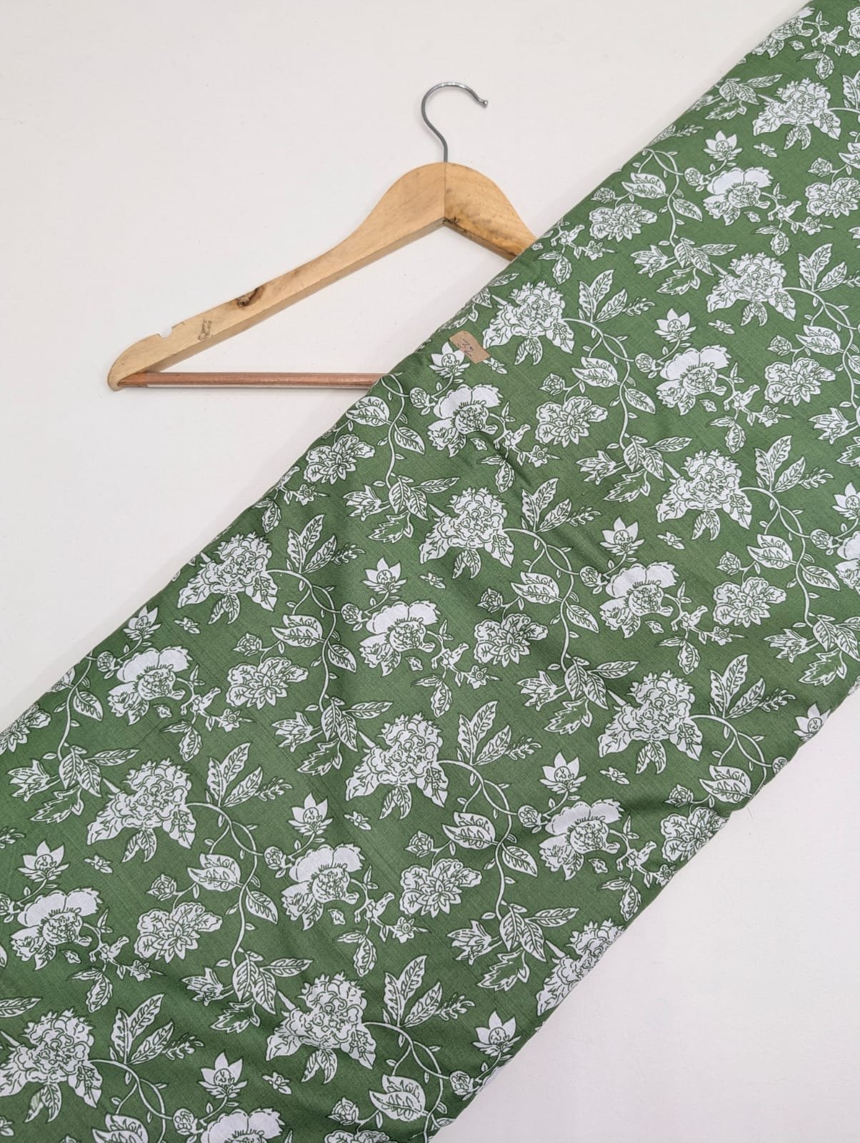 Green cotton fabric with white floral design