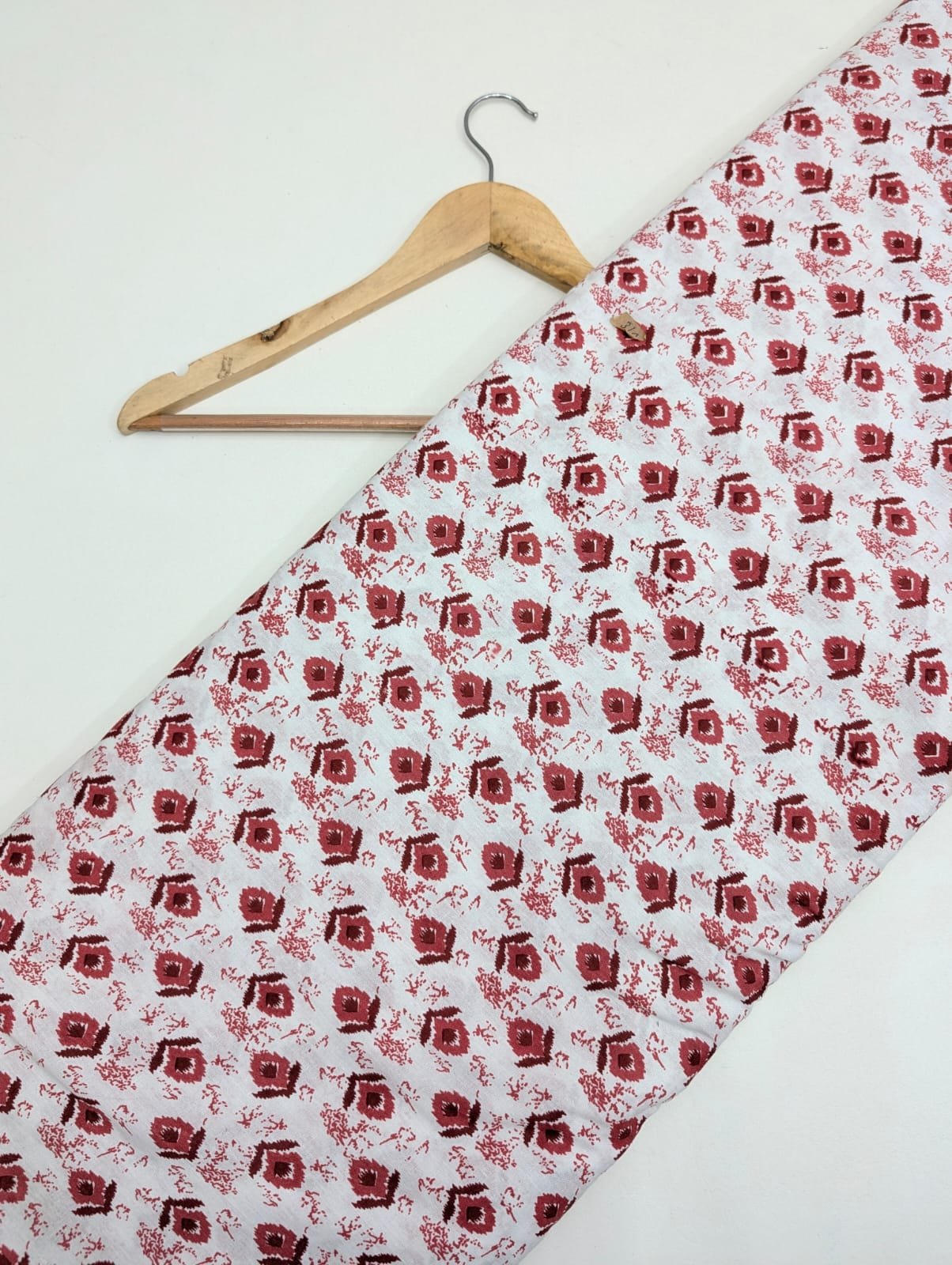 White cotton fabric with red floral print