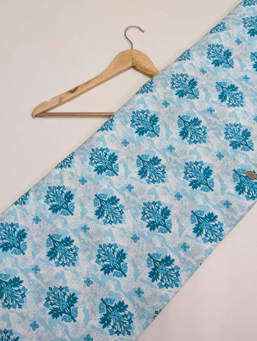 Blue paisley print on white cotton fabric