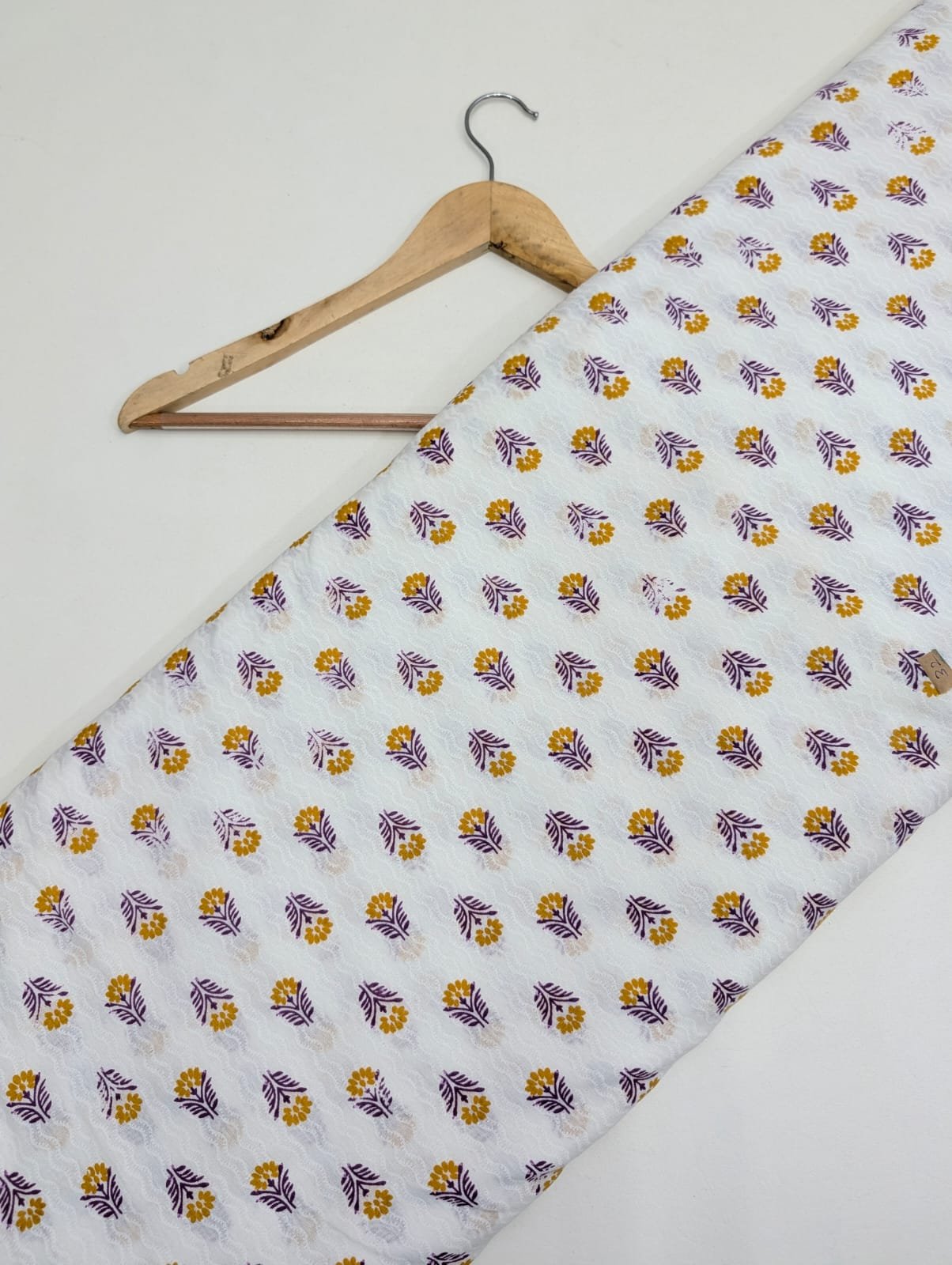 Yellow floral print on white cotton fabric