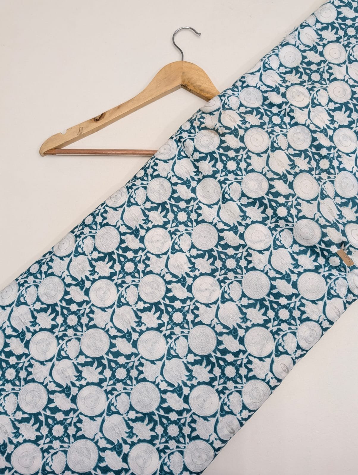 Teal cotton fabric with circular white motifs
