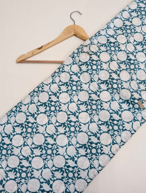 Teal cotton fabric with circular white motifs
