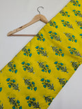 Yellow cotton fabric with green leafy print