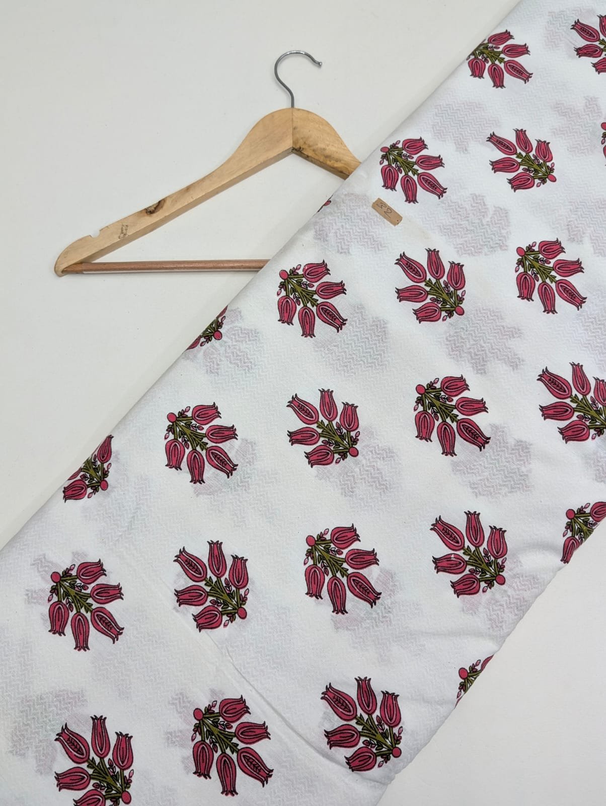 White cotton fabric with red floral designs