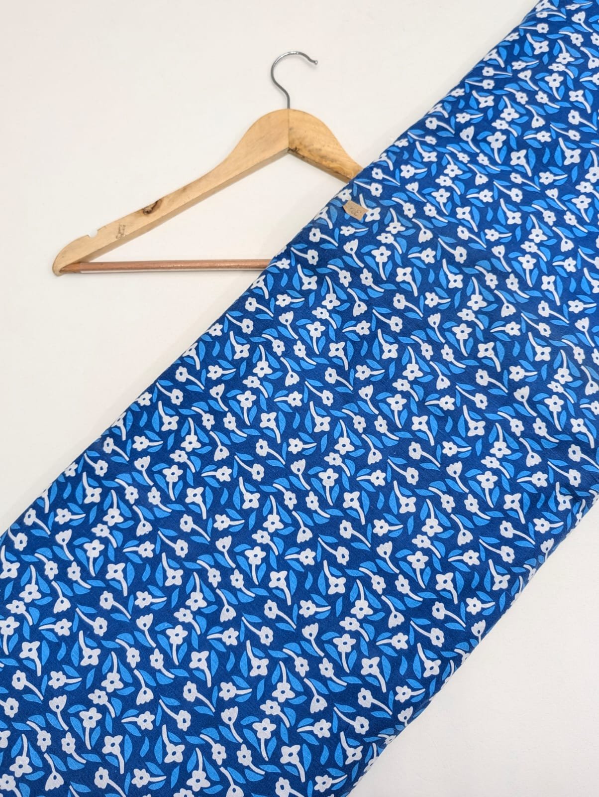 Blue cotton fabric with white floral pattern