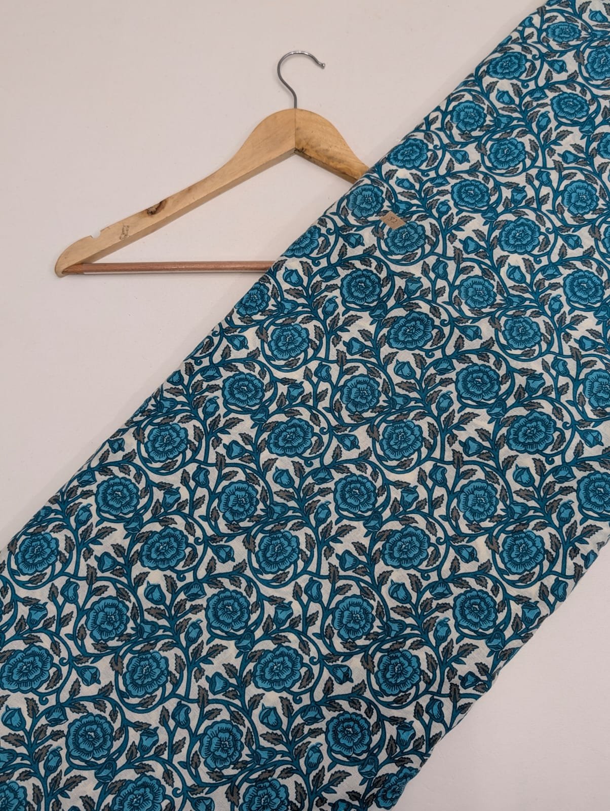 Teal cotton fabric with intricate floral pattern