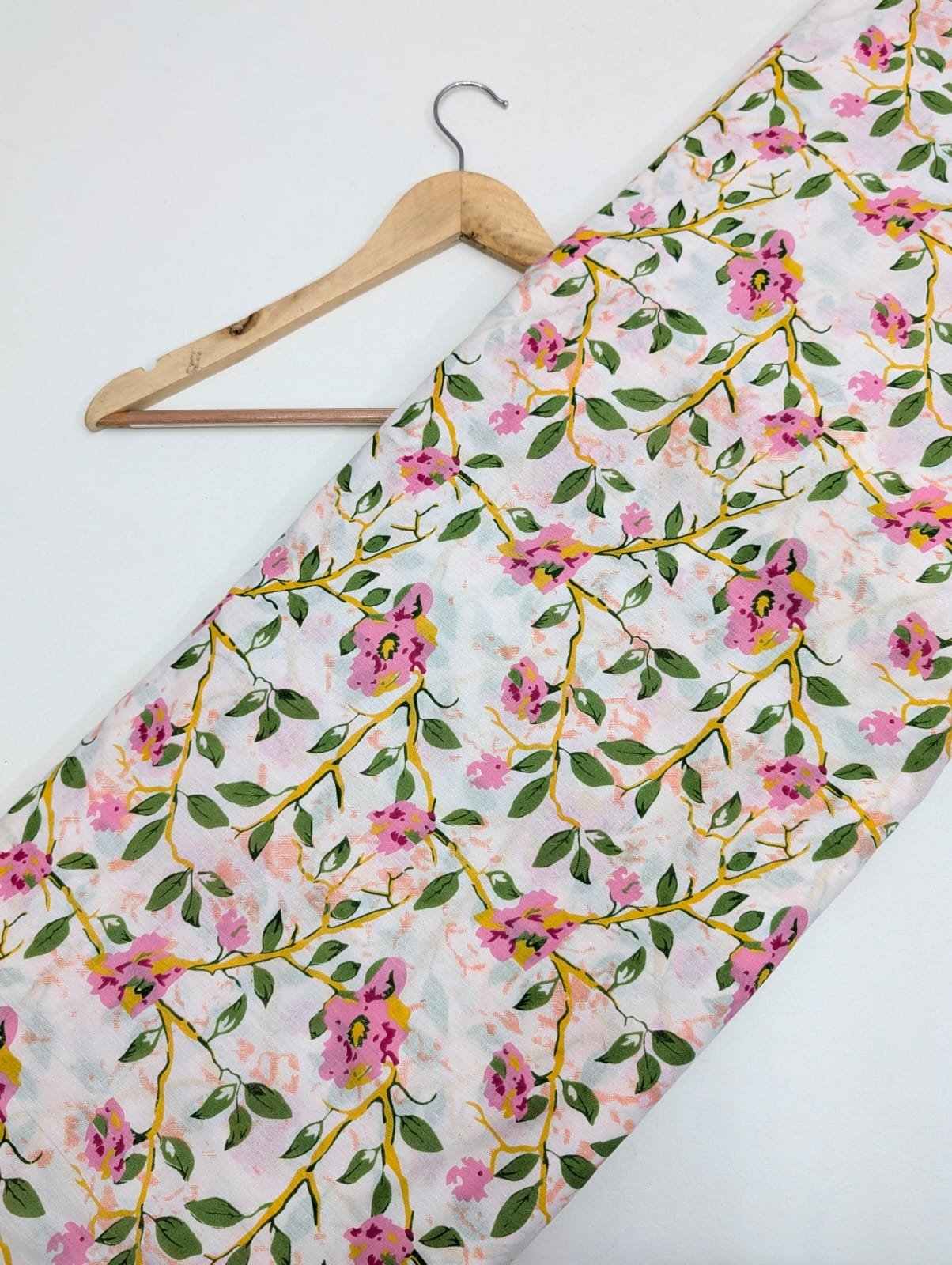 White cotton fabric with pink floral vine pattern