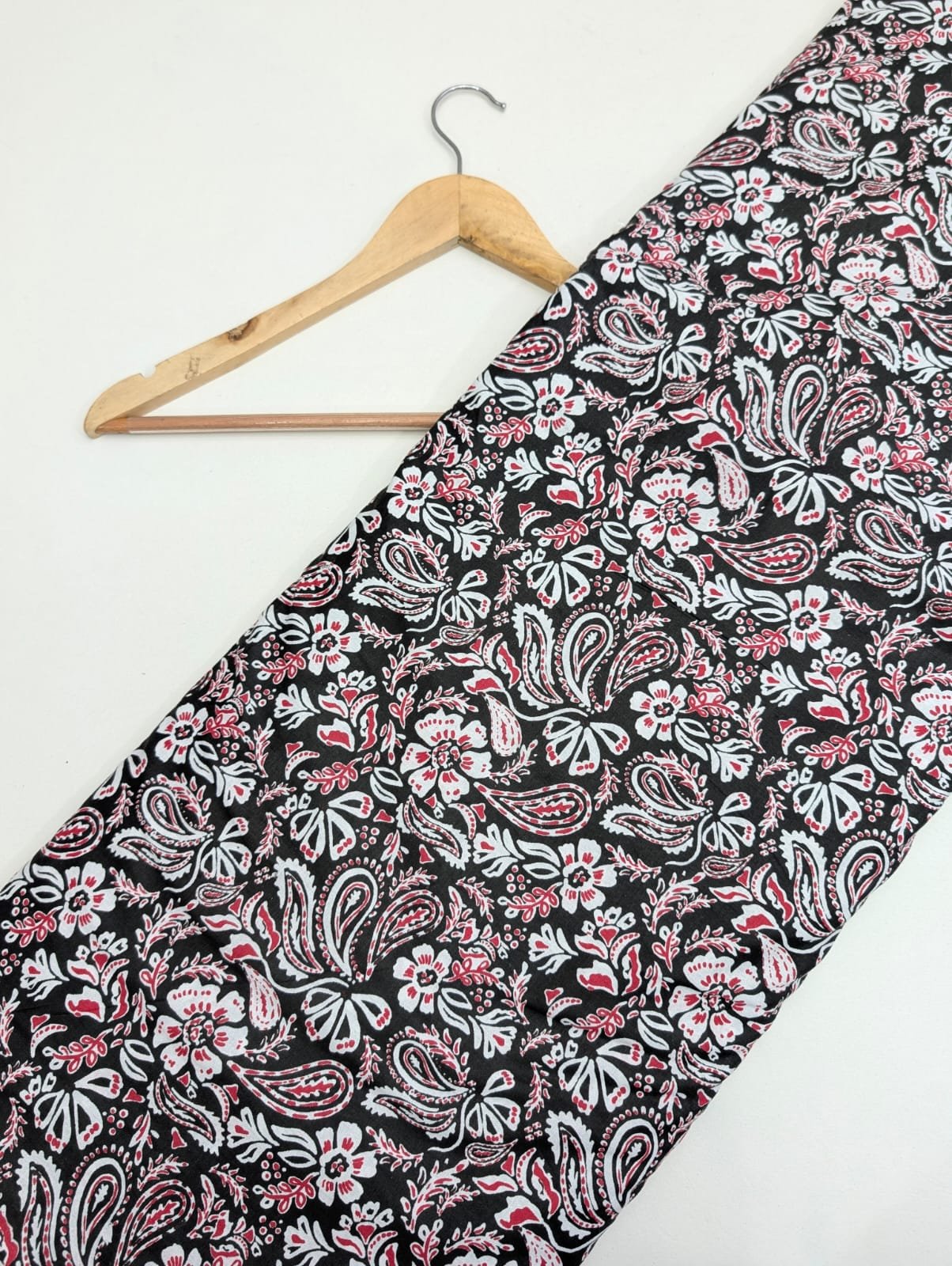 Black paisley printed cotton fabric with red accents